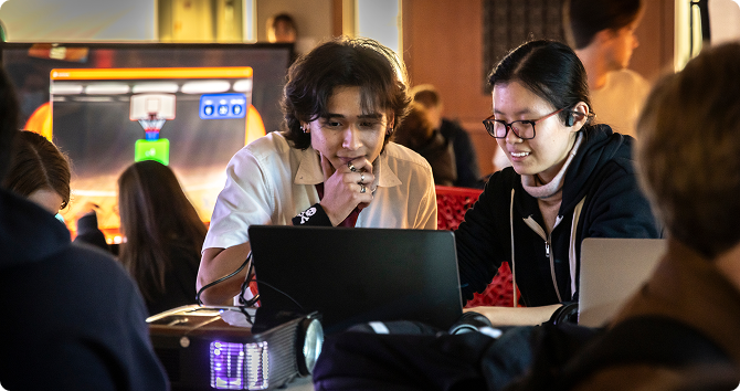 Students working together over laptop