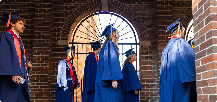 Students in caps and gowns walking